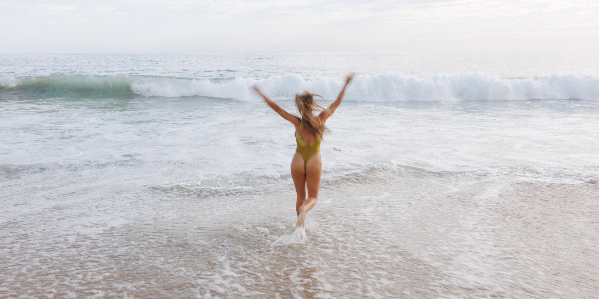Woman running in the ocean