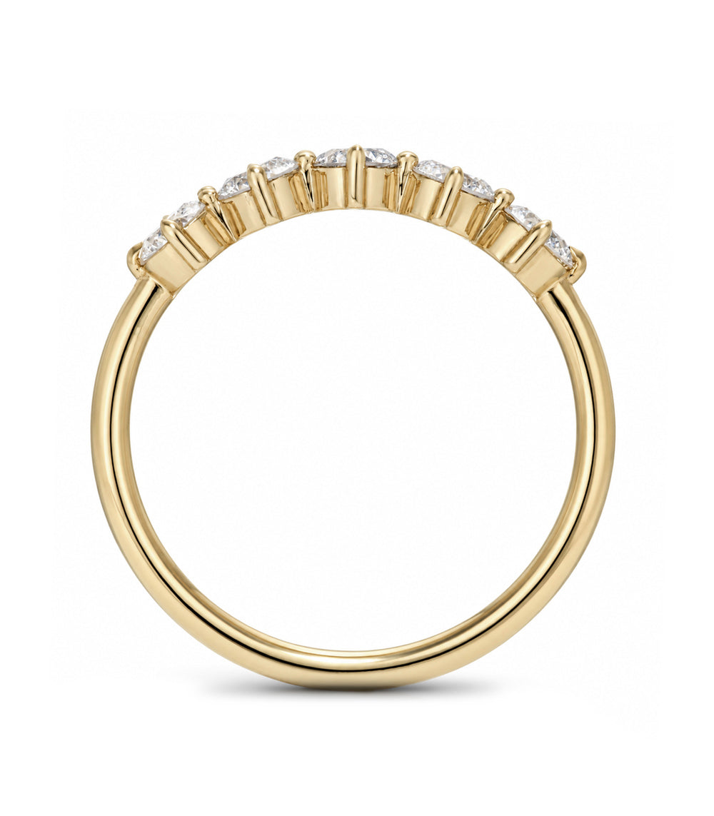 A yellow gold ring with a curved row of small clear stones along the top, shown on a plain white background.