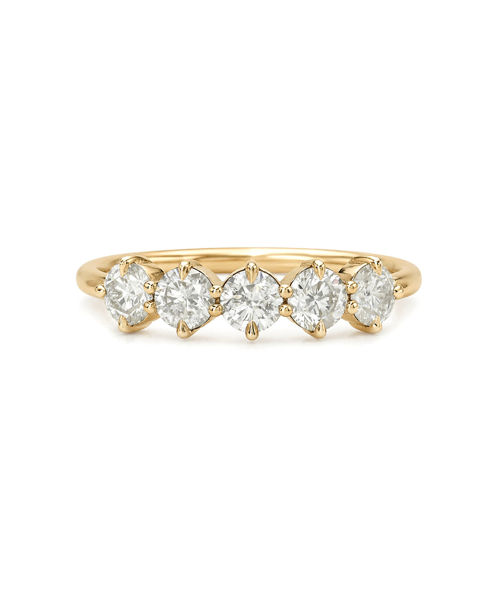 Gold 5 stone ring with small diamonds on a white background