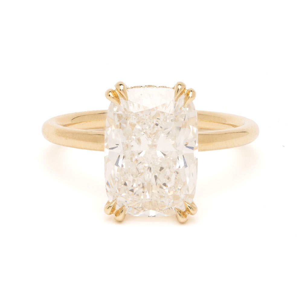 Gold ring with a large diamond on a white background
