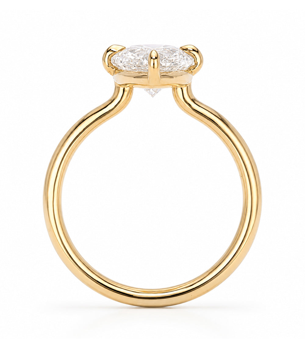 A yellow gold solitaire engagement ring featuring a oval brilliant-cut white diamond in a prong setting, shown on a clean white background.