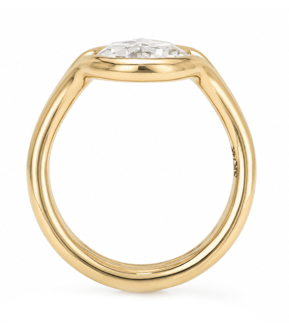 A yellow gold solitaire bezel set double band engagement ring featuring a oval rose cut white diamond in a prong setting, shown on a clean white background.