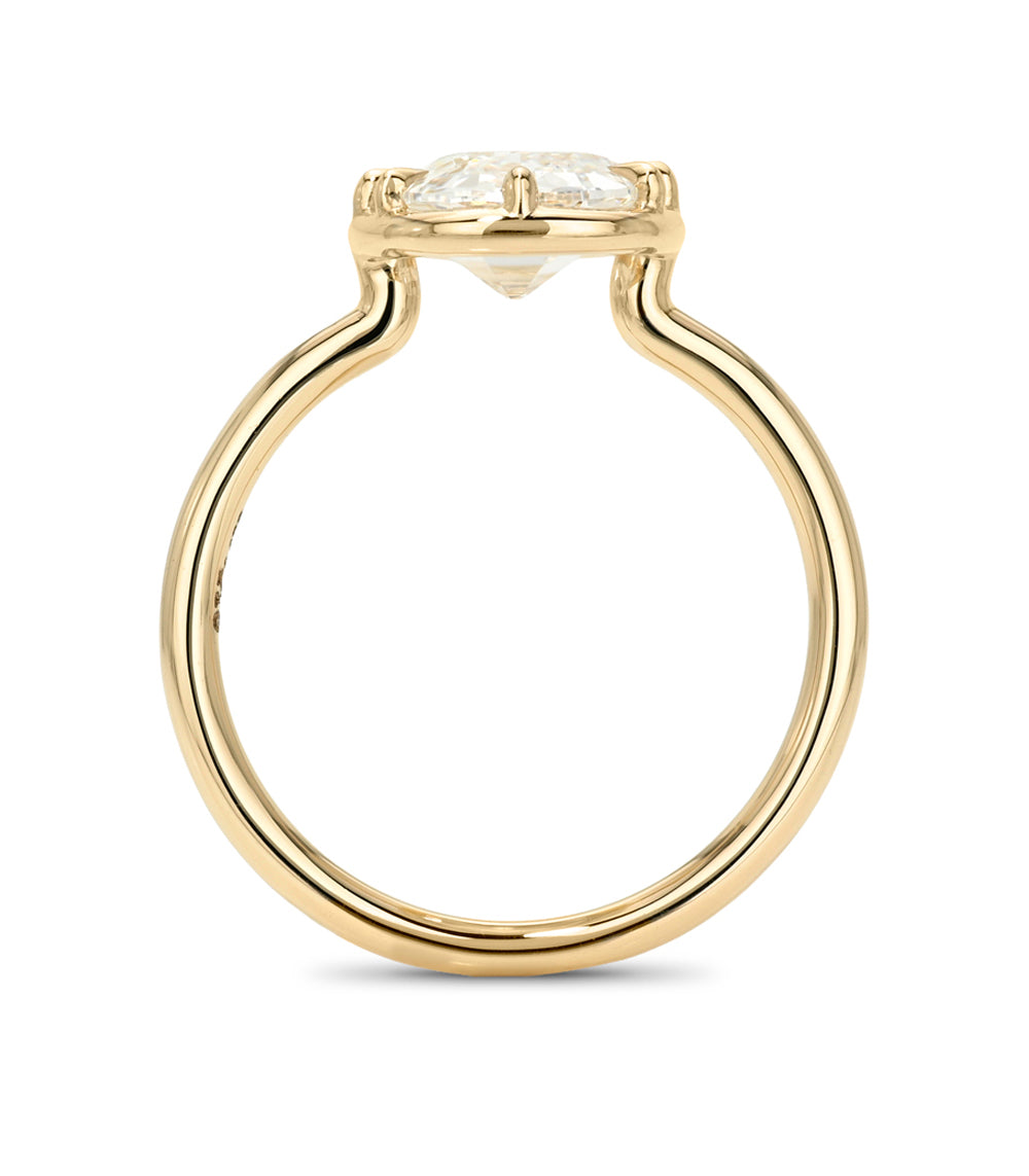 A yellow gold solitaire engagement ring featuring a round brilliant-cut diamond center stone in a four-prong setting, shown on a clean white background.