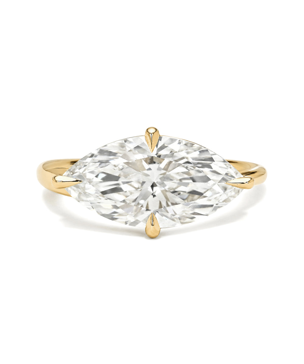Gold ring with a large diamond on a white background