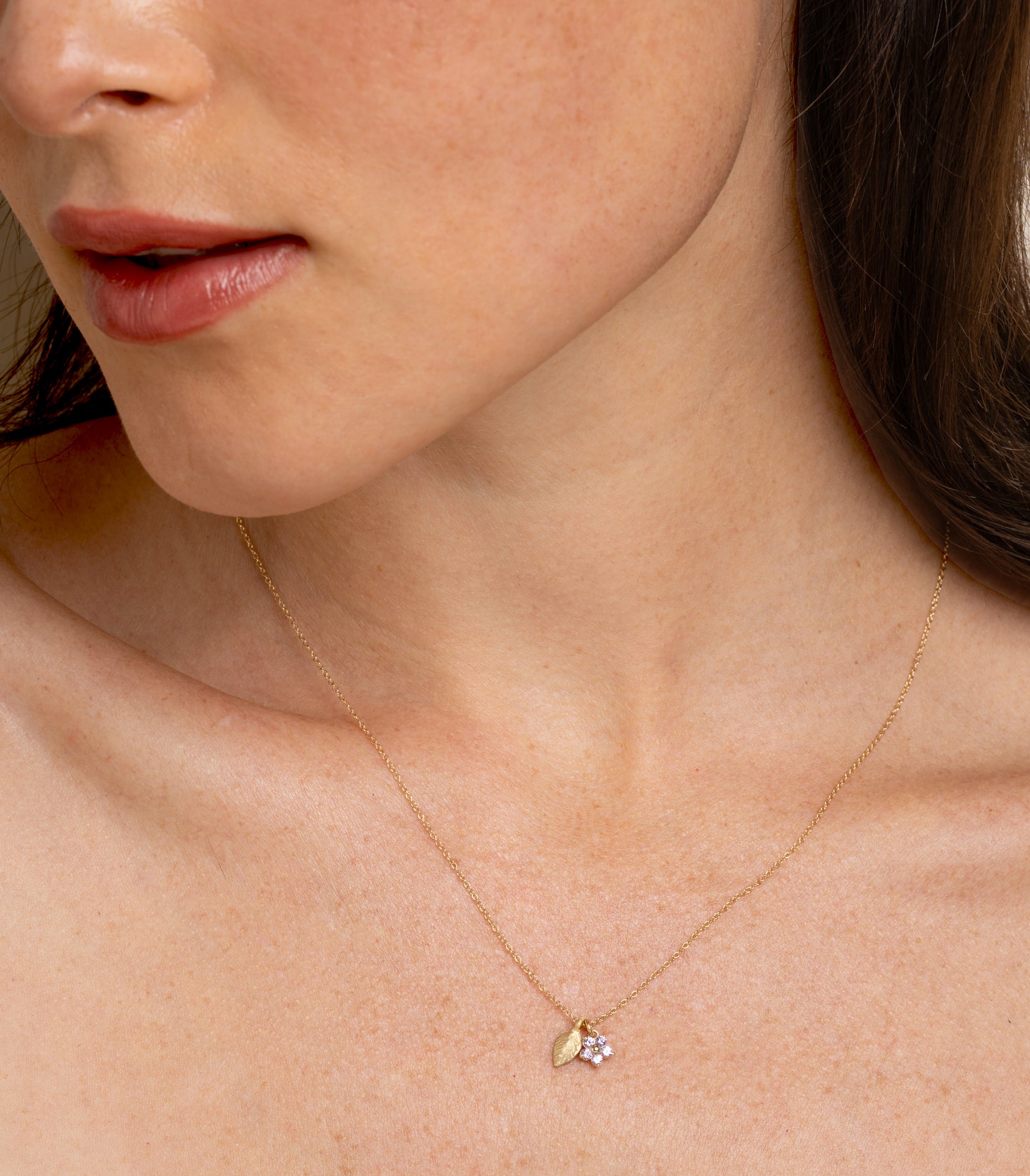 Let It Grow- Daisy and Leaf Charm Necklace by LF-N2L-PS, gold chain with daisy and leaf pendant on model