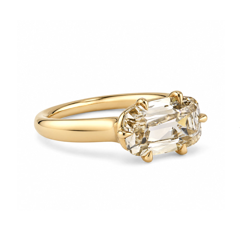 side view of a champagne old mine cut elongated cushion lab diamond on with tapered 14k gold band with six eagle claw prongs. 