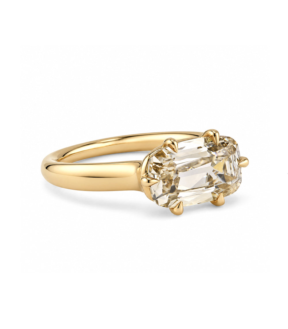 side view of a champagne old mine cut elongated cushion lab diamond on with tapered 14k gold band with six eagle claw prongs. 