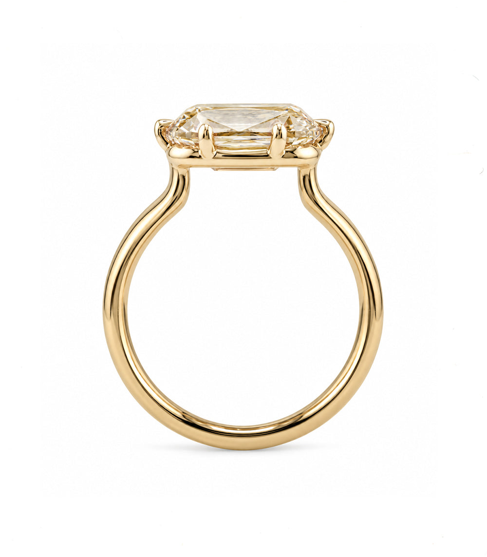 profile view of a Champagne diamond ring with an elongated old mine cut lab diamond in a soft blush-brown color. inimal setting with claw prongs. 