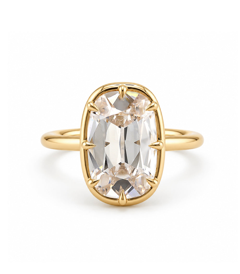 champagne colored old mine cut elongated cushion lab diamond in an antique style setting with claw prongs in 14K yellow gold