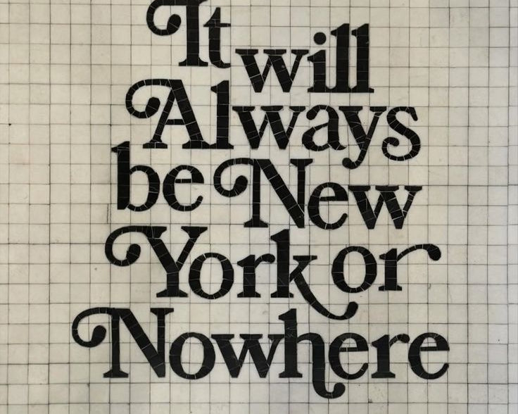 A square decorative tile or wall sign featuring the phrase 'It will always be New York or Nowhere' in large black script over a cream grid background, with black Greek key borders at the top and bottom and thin gold horizontal bars.