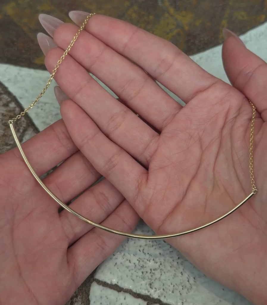 14K yellow gold half collar chain necklace shown with hands.