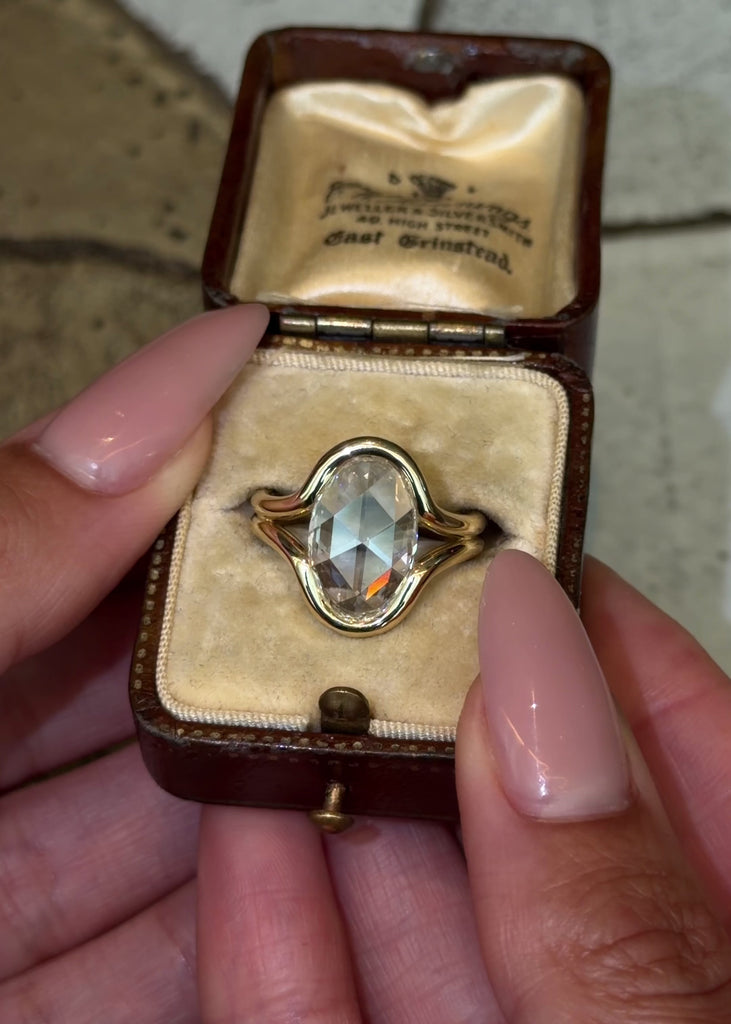 Lab grown rose cut oval diamond in a split shank bezel design in 14K yellow gold 