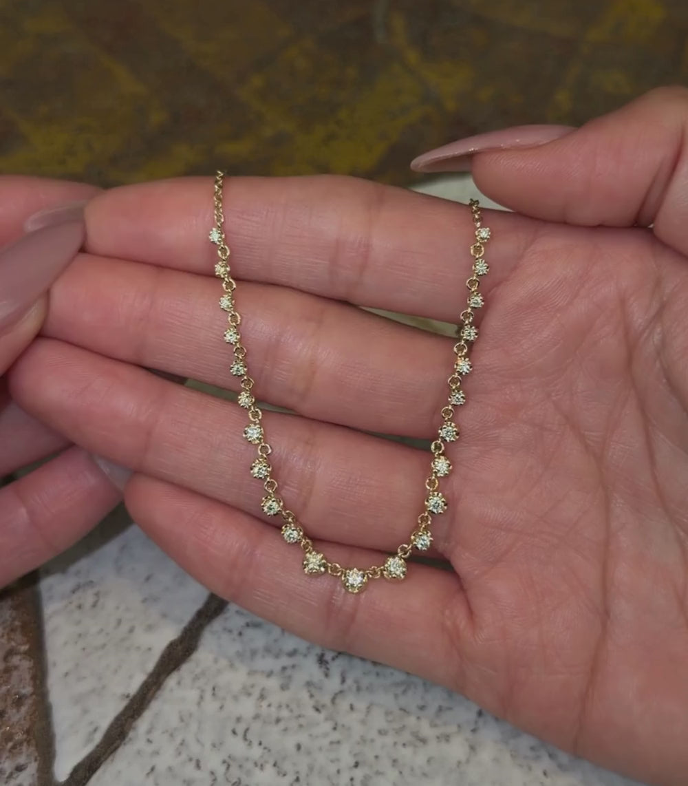 14k yellow gold chain necklace with half diamond collet details shown with hands.