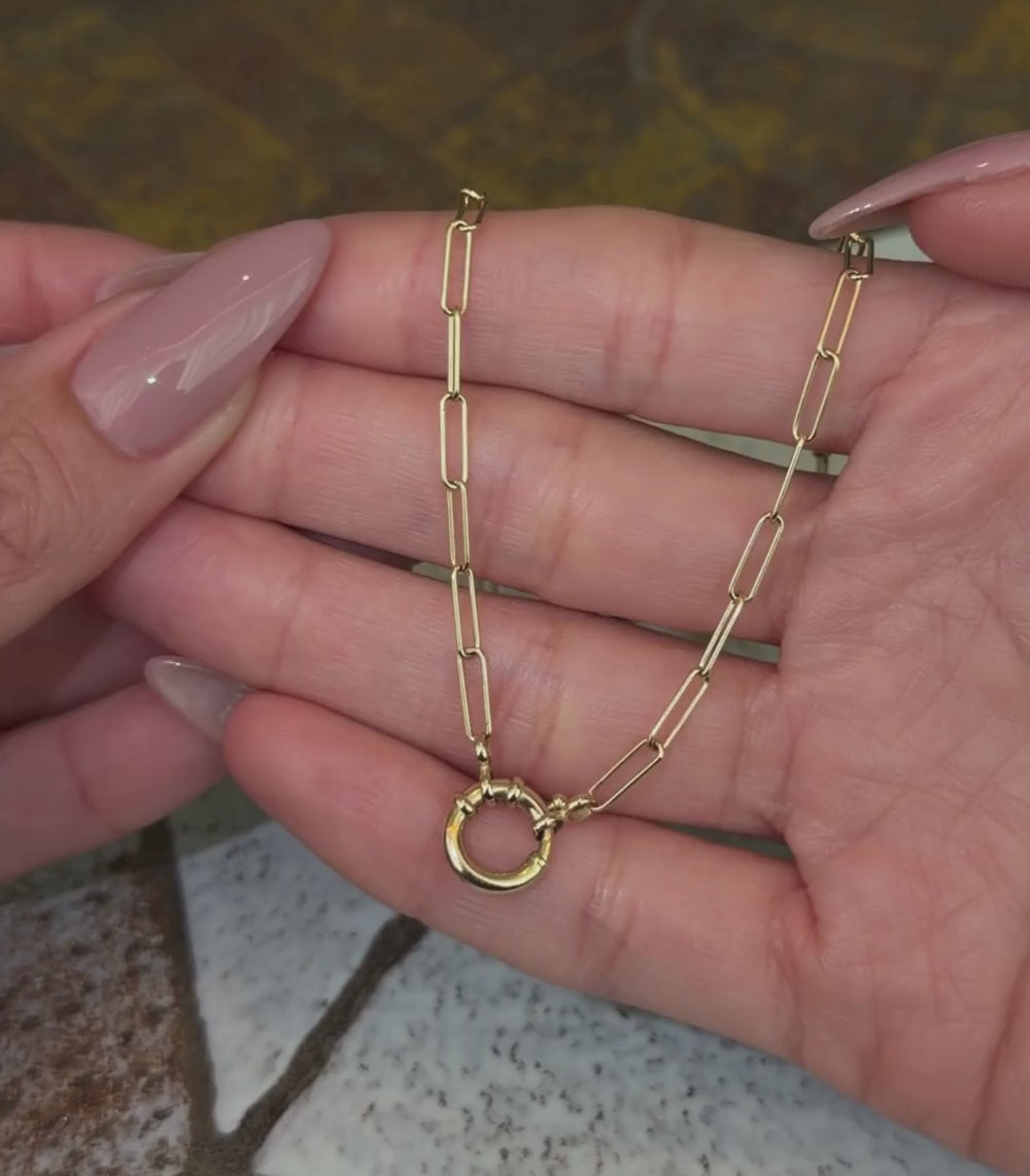 14K yellow gold cable chain necklace with spring ring closure, shown with hands.
