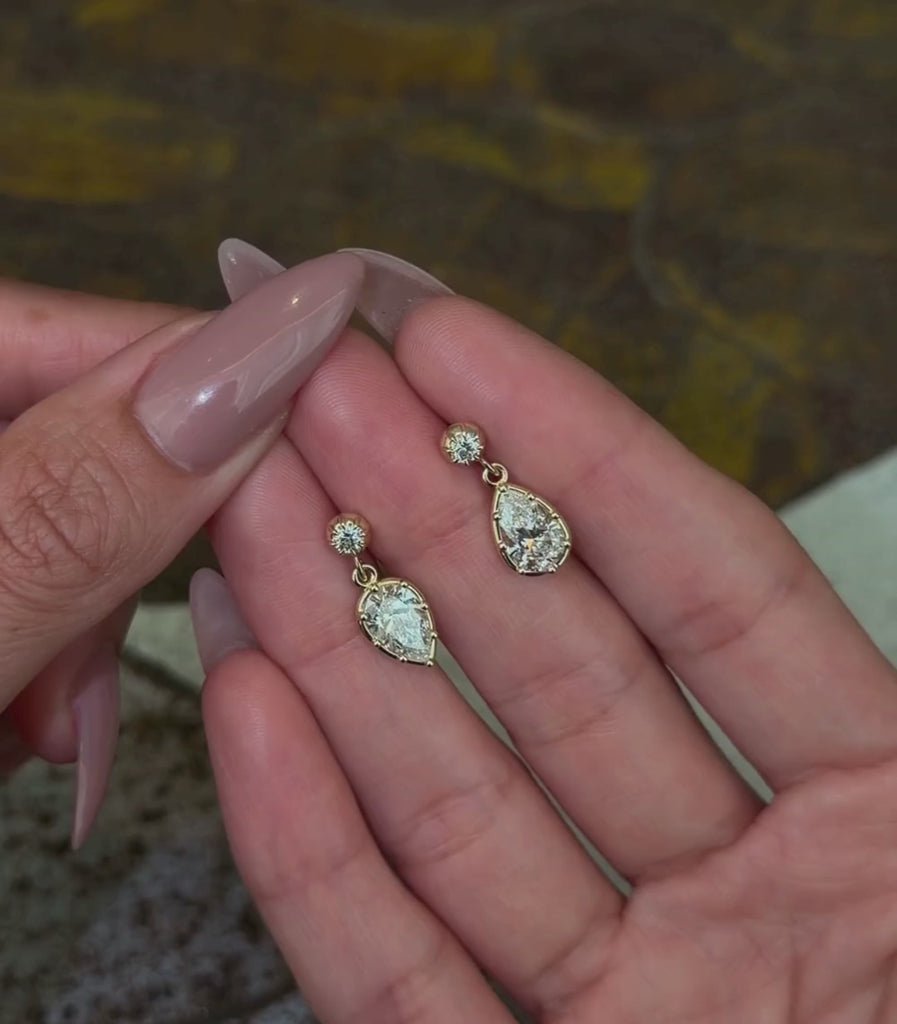 14K yellow gold diamond stud with alternating pear drop diamond details, shown with hands.