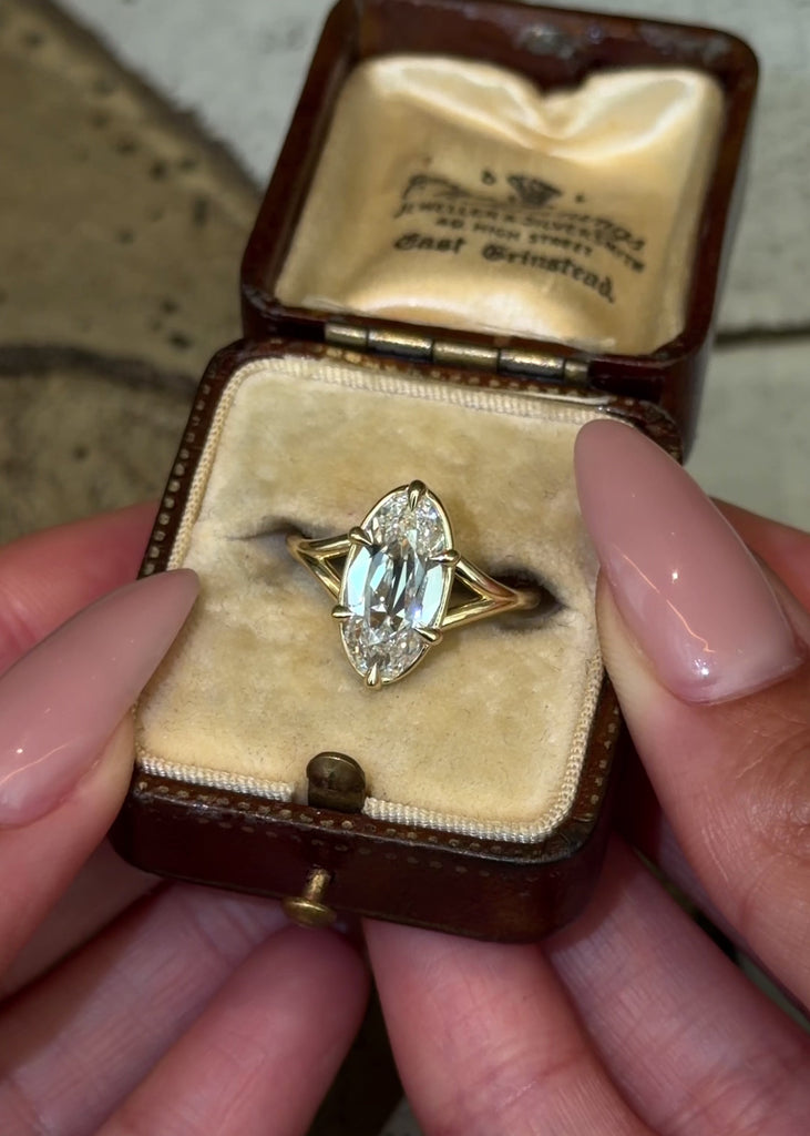 split shank design with eagle claw prongs featuring an old mine cut oval lab diamond in 14k yellow gold