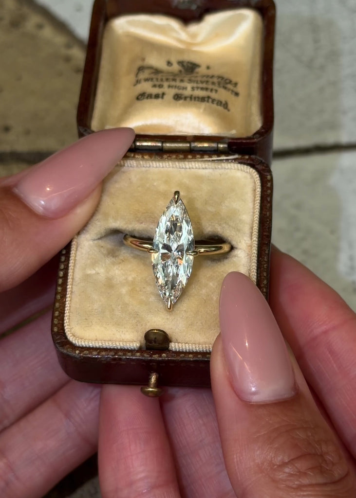 Elongated brilliant cut marquise lab grown diamond engagement ring in a minimal compass prong setting design in 14k shiny yellow gold