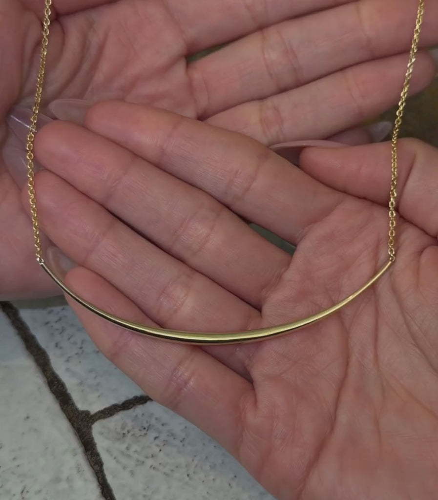 14K yellow gold bar chain necklace shown with hands.