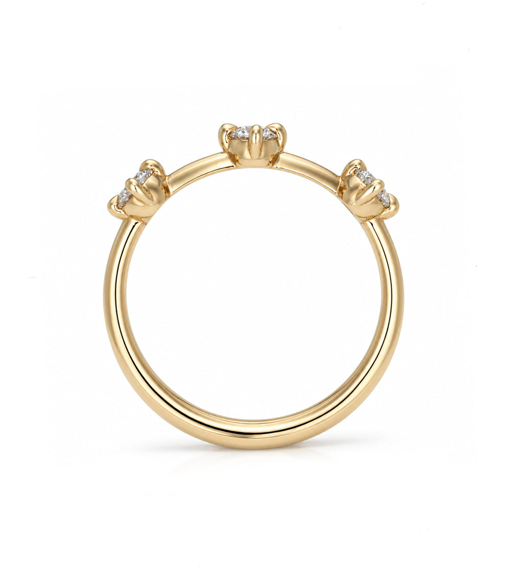 A yellow gold ring featuring three small diamond clusters set at the top of a polished band, shown against a plain white background.