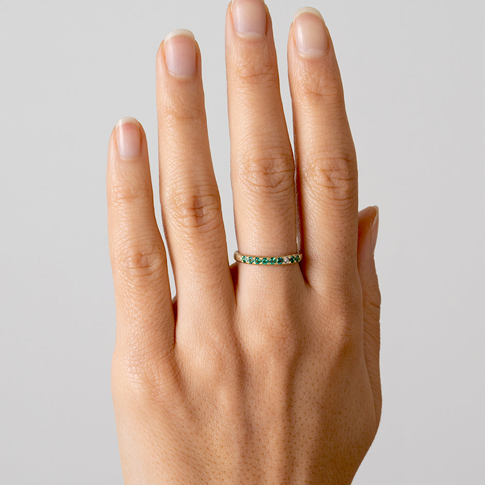 Vintage Inspired Stacking Band LF-R1-ES 14K yellow gold with green stones, shiny band on hand