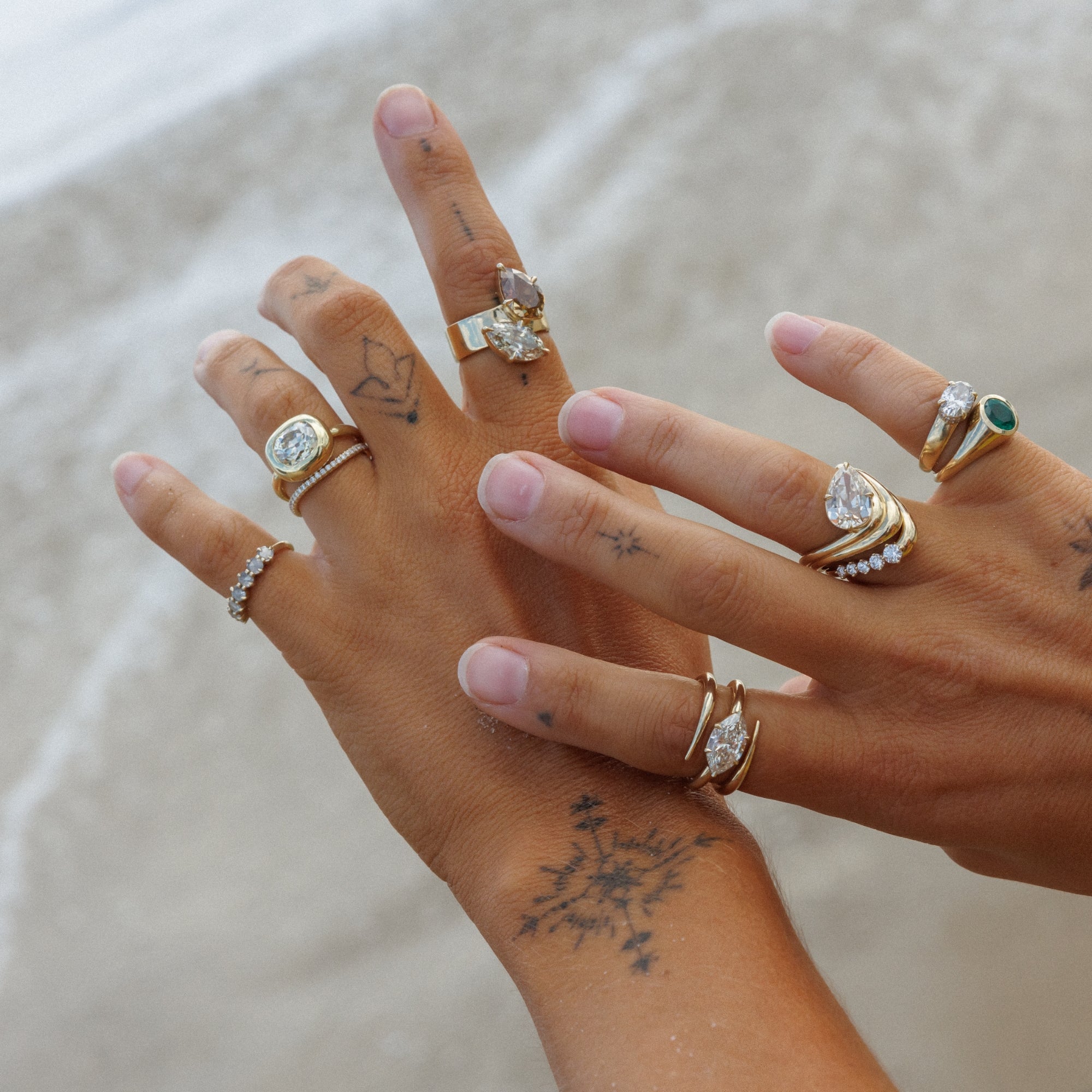 Woman Holding Hands Over Ocean Showing Her One Of A Kind Unique Fine Jewelry Engagement Rings With Natural Champagne Diamonds Conflict Free Stones