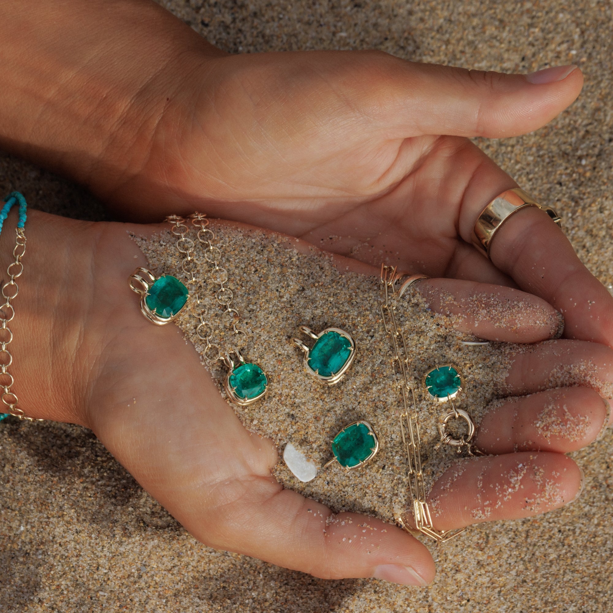 Woman Holding Hands With Sand Showing Emerald Pendants In Palms Of Hand Editorial Fine Jewelry Style